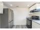 Open-concept kitchen featuring stainless steel refrigerator, white cabinets, and black oven at 161 Adair Se Ave, Atlanta, GA 30315