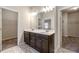 Double vanity bathroom with dark brown cabinets and closets at 2250 Trelipe Dr, Lawrenceville, GA 30044