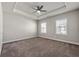 Large main bedroom with tray ceiling, carpet, and windows at 2250 Trelipe Dr, Lawrenceville, GA 30044