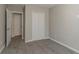 Bedroom with grey carpet, double-door closet, and access to another room at 2675 Park Ave, Austell, GA 30106