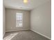 Bright bedroom with grey carpet, large window, and ample wall space at 2675 Park Ave, Austell, GA 30106