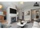 Virtually staged living room with fireplace and kitchen view at 2675 Park Ave, Austell, GA 30106