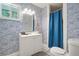 Bathroom with a shower/tub combo and blue wave patterned walls at 4291 Lamar St, Decatur, GA 30035
