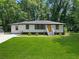 Newly renovated house with a yellow door and spacious yard at 4291 Lamar St, Decatur, GA 30035