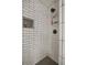 Clean shower with white subway tile and black herringbone floor at 4291 Lamar St, Decatur, GA 30035