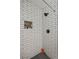 Clean shower with white subway tile and black herringbone floor at 4291 Lamar St, Decatur, GA 30035