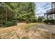 Spacious backyard with a wooden deck, patio, and lush greenery, perfect for outdoor living and entertaining at 101 Chestnut Dr, Canton, GA 30114