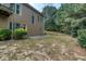 View of the home's backyard with greenery and a patio at 101 Chestnut Dr, Canton, GA 30114