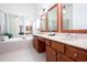 Primary bath with soaking tub, vanity, dark wood cabinets and large mirrors at 101 Chestnut Dr, Canton, GA 30114