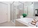 Bright bathroom featuring walk-in shower, soaking tub, and modern tile at 101 Chestnut Dr, Canton, GA 30114