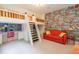 Bright bedroom with a custom bunk bed with white ladders, red sofa, and comic-themed wallpaper at 101 Chestnut Dr, Canton, GA 30114
