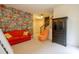 Bedroom featuring fun comic wallpaper, a red sofa, and black armoire at 101 Chestnut Dr, Canton, GA 30114