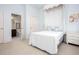Cozy bedroom with a canopy bed, soft blue walls, and an adjacent bathroom, ideal for restful nights and convenience at 101 Chestnut Dr, Canton, GA 30114
