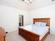 Bright bedroom featuring a wooden bed frame, neutral carpet and coastal-themed decor at 101 Chestnut Dr, Canton, GA 30114