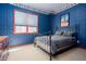Unique bedroom with themed wallpaper, gray bedding, and a window bringing in natural light, creating an inviting retreat at 101 Chestnut Dr, Canton, GA 30114