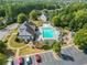 Aerial view of a stunning community pool with lounge chairs, a playground, and parking at 101 Chestnut Dr, Canton, GA 30114