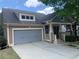 Charming home featuring a gray garage door and covered front porch, set against a blue sky at 101 Chestnut Dr, Canton, GA 30114