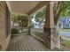 Inviting front porch features wood decking, brick columns, and serene neighborhood views at 101 Chestnut Dr, Canton, GA 30114