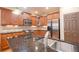 Open-concept kitchen with granite countertops, stainless appliances, and spacious island with sink at 101 Chestnut Dr, Canton, GA 30114