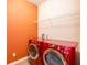 Laundry room with red washer and dryer at 101 Chestnut Dr, Canton, GA 30114