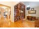 Spacious living room with built-in bookcase, hardwood floors, and seamless flow into the hallway at 101 Chestnut Dr, Canton, GA 30114