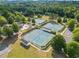 Aerial shot of the community tennis courts, surrounded by trees and walking paths, for outdoor recreation at 101 Chestnut Dr, Canton, GA 30114