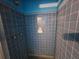 A small shower with blue tile walls at 201 E Simon E Ter, Atlanta, GA 30318