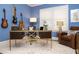 Bright blue office featuring modern desk, guitars mounted on the wall and decorative rug at 210 Marjean Way, Alpharetta, GA 30009