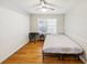 This bedroom has wood floors, neutral walls, a ceiling fan, and a metal bed frame at 3337 Toney Dr, Decatur, GA 30032