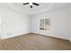 Spacious bedroom with wood floors, a tray ceiling, and a large window, creating a tranquil and inviting retreat at 160 Lofty Eagle Ln, Fayetteville, GA 30214