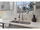 Bright kitchen featuring a stainless steel sink, modern faucet, quartz countertop, and white subway tile backsplash at 160 Lofty Eagle Ln, Fayetteville, GA 30214