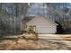 Tan house with white garage door and landscaping at 3121 Jessica Dr, Douglasville, GA 30135