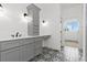 Gray vanity with white countertop, patterned floor tile, and a shower at 115 Palisade Dr, Rydal, GA 30171