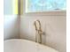 Freestanding tub with a gold faucet and textured wall tile at 115 Palisade Dr, Rydal, GA 30171