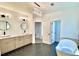 Double vanity with beige cabinets, hexagon floor tile, and a freestanding tub at 115 Palisade Dr, Rydal, GA 30171