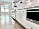 White kitchen cabinets with stainless steel appliances and dark hardwood floors at 115 Palisade Dr, Rydal, GA 30171