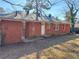 Exterior view of a single story home with a brick exterior and spacious backyard at 1820 Arkose Dr, Atlanta, GA 30316