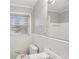 Bright bathroom featuring white tiles and fixtures, a sink, and a window for natural light at 1820 Arkose Dr, Atlanta, GA 30316