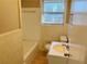 Cozy bathroom featuring white tiles, a toilet, and a vanity sink with bright natural light at 1820 Arkose Dr, Atlanta, GA 30316