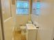 Compact bathroom with tiled walls, white fixtures, and a window providing natural light at 1820 Arkose Dr, Atlanta, GA 30316