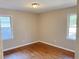 A bright bedroom features hardwood floors and two windows letting in natural light at 1820 Arkose Dr, Atlanta, GA 30316