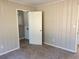 Bedroom with neutral walls and gray carpet includes a doorway to another room at 1820 Arkose Dr, Atlanta, GA 30316