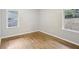 Well-lit bedroom featuring hardwood floors and two windows at 1820 Arkose Dr, Atlanta, GA 30316