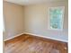 A bright bedroom features hardwood floors and a window letting in natural light at 1820 Arkose Dr, Atlanta, GA 30316