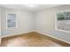 Bedroom with hardwood floors, two windows offering natural light, and neutral paint creates a cozy atmosphere at 1820 Arkose Dr, Atlanta, GA 30316