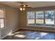 Bedroom with neutral paint, new vinyl floors, a ceiling fan, and a double hung window offering views of the side yard at 1820 Arkose Dr, Atlanta, GA 30316