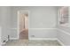 Dining room features vinyl flooring, gray walls, and a doorway to the next room at 1820 Arkose Dr, Atlanta, GA 30316