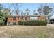 Brick ranch house with a well-maintained lawn and shrubs at 1820 Arkose Dr, Atlanta, GA 30316