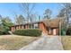 Brick home with a covered carport, green lawn, and classic design elements at 1820 Arkose Dr, Atlanta, GA 30316