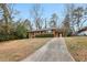 Well-kept brick home with a carport and established landscaping along a concrete driveway at 1820 Arkose Dr, Atlanta, GA 30316